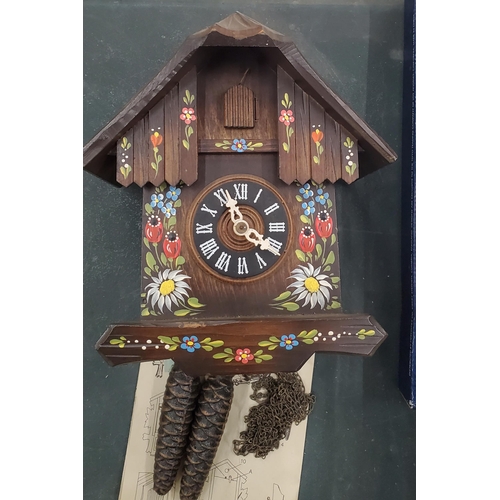 141 - TWO SWISS STYLE WOODEN CUCKOO CLOCKS WITH WEIGHTS AND INSTRUCTIONS