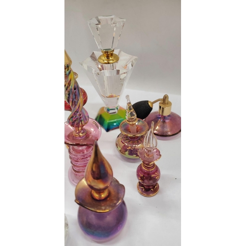 172 - A COLLECTION OF GLASS SCENT BOTTLES WITH STOPPERS