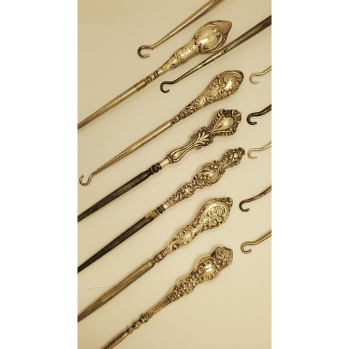 215 - A COLLECTION OF THIRTEEN VICTORIAN AND LATER SILVER HANDLED BUTTON HOOKS