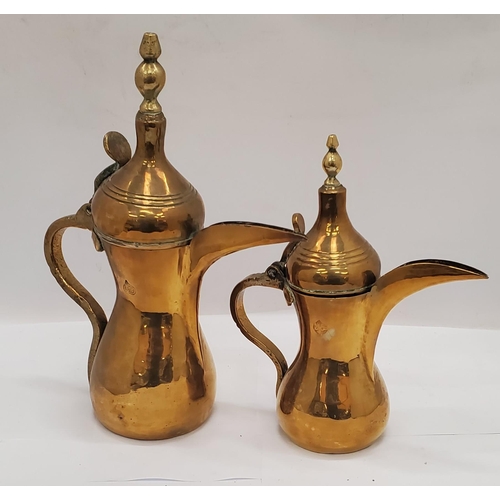 256 - A QUANTITY OF BRASSWARE TO INCLUDE ASIAN STYLE COFFEE POTS, A LARGE COPPER AND BRASS KETTLE, TRAYS, ... 