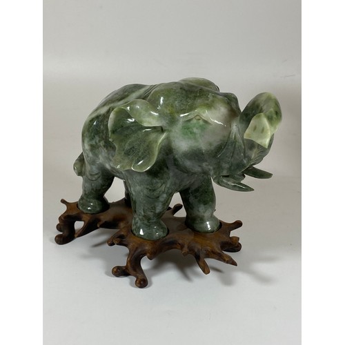 300 - A PAIR OF CHINESE JADEITE / JADE HARDSTONE ELEPHANT MODELS ON CARVED WOODEN STANDS, HEIGHT 16CM, LEN... 