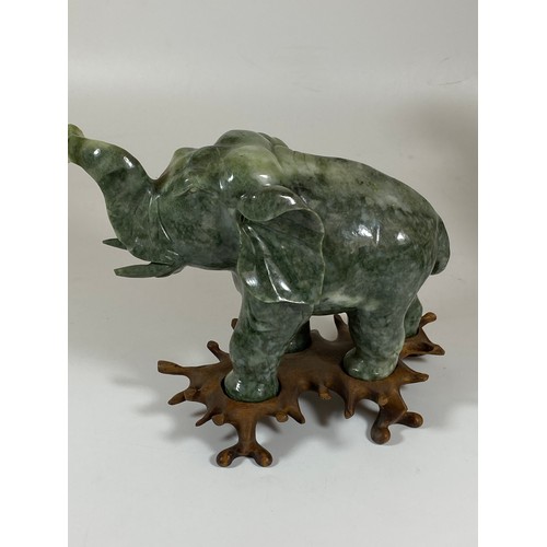 300 - A PAIR OF CHINESE JADEITE / JADE HARDSTONE ELEPHANT MODELS ON CARVED WOODEN STANDS, HEIGHT 16CM, LEN... 