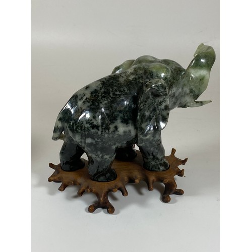 300 - A PAIR OF CHINESE JADEITE / JADE HARDSTONE ELEPHANT MODELS ON CARVED WOODEN STANDS, HEIGHT 16CM, LEN... 