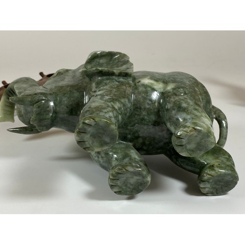 300 - A PAIR OF CHINESE JADEITE / JADE HARDSTONE ELEPHANT MODELS ON CARVED WOODEN STANDS, HEIGHT 16CM, LEN... 