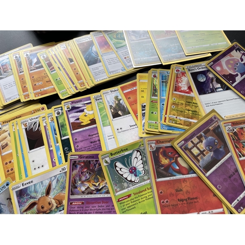 115 - TWO TINS OF ASSORTED POKEMON CARDS, HOLOS ETC