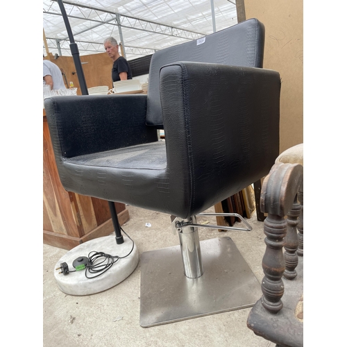 2939 - A BLACK LEATHER SWIVEL PUMP ACTION BARBERS CHAIR ON POLISHED METALWARE BASE