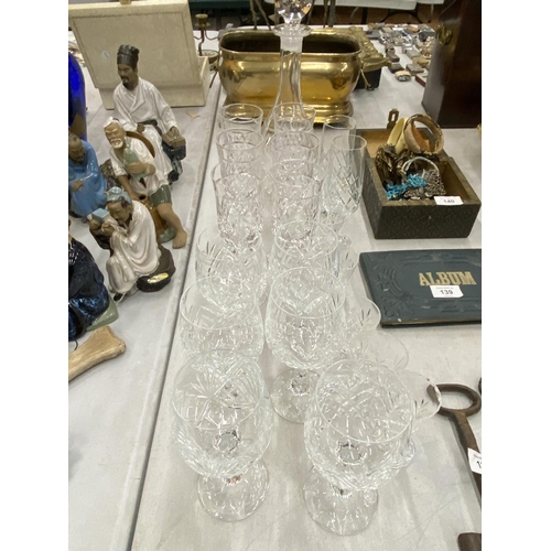 141 - A QUANTITY OF CUT GLASS TO INCLUDE A DECANTER, WINE AND SHERRY GLASSESS, ETC