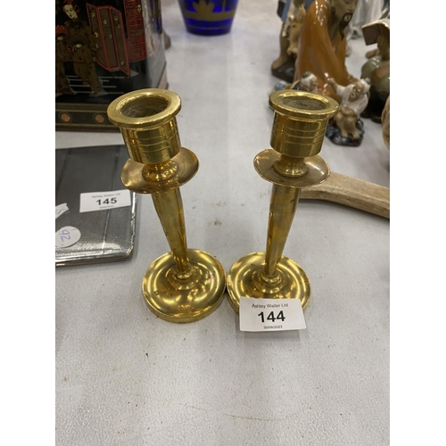 144 - A TRENCH ART SMALL PAIR OF HEAVY BRASS CANDLESTICKS, HEIGHT 13CM