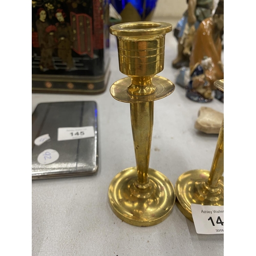 144 - A TRENCH ART SMALL PAIR OF HEAVY BRASS CANDLESTICKS, HEIGHT 13CM