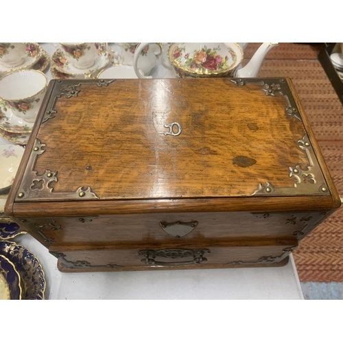 193 - A VICTORIAN GOTHIC OAK SMOKERS CHEST WITH METAL BANDING AND SIDE HANDLES