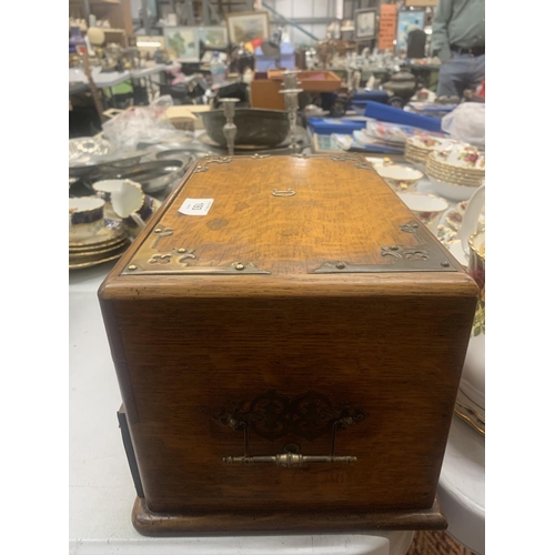 193 - A VICTORIAN GOTHIC OAK SMOKERS CHEST WITH METAL BANDING AND SIDE HANDLES