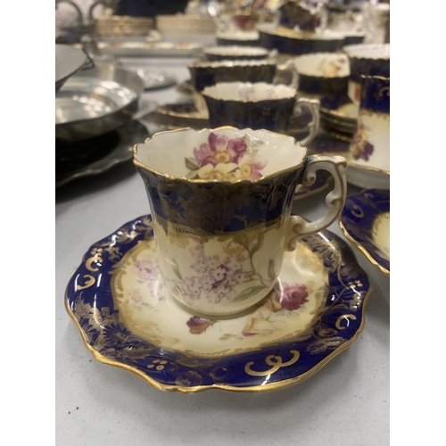 194 - AN ANTIQUE CHINA TEASET TO INCLUDE A SUGAR BOWL, CREAM JUG, CUPS, SAUCERS, AND SIDE PLATES