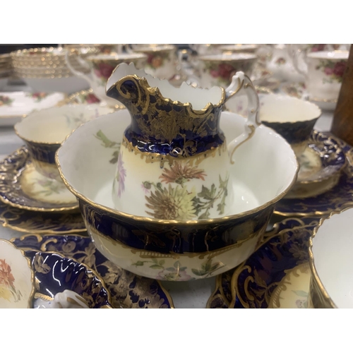 194 - AN ANTIQUE CHINA TEASET TO INCLUDE A SUGAR BOWL, CREAM JUG, CUPS, SAUCERS, AND SIDE PLATES