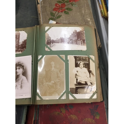 217 - FOUR VINTAGE POSTCARD ALBUMS CONTAINING A QUANTITY OF POSTCARDS TO INCLUDE HUMOROUS EXAMPLES