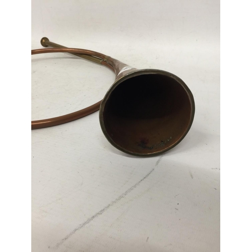 274 - A VINTAGE COILED COPPER HUNTING HORN