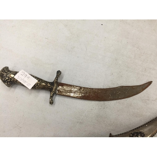 299 - A DECORATIVE CURVED BLADE DAGGER AND SHEATH