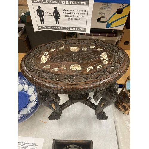 17 - AN ORIENTAL CARVED HARDWOOD TABLE WITH ELEPHANT DESIGN LEGS