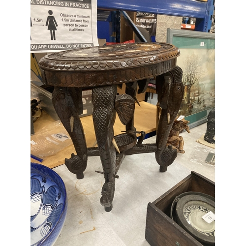 17 - AN ORIENTAL CARVED HARDWOOD TABLE WITH ELEPHANT DESIGN LEGS