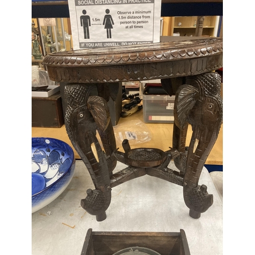 17 - AN ORIENTAL CARVED HARDWOOD TABLE WITH ELEPHANT DESIGN LEGS