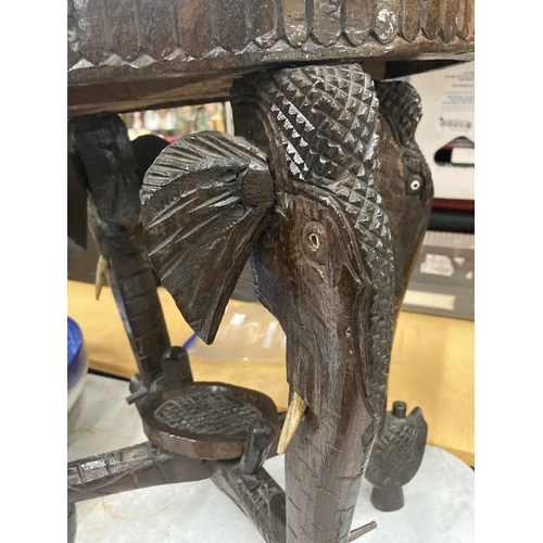 17 - AN ORIENTAL CARVED HARDWOOD TABLE WITH ELEPHANT DESIGN LEGS