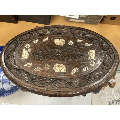 17 - AN ORIENTAL CARVED HARDWOOD TABLE WITH ELEPHANT DESIGN LEGS