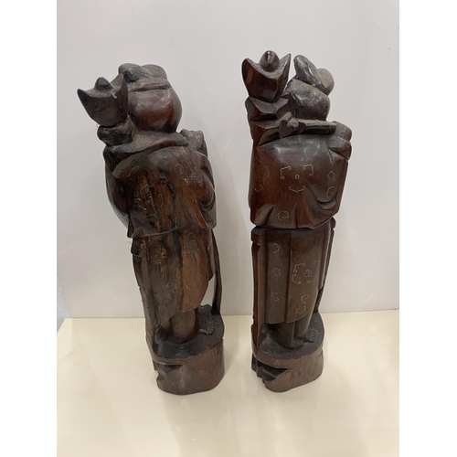 30 - A PAIR OF CARVED HARDWOOD ORIENTAL FIGURES, HEIGHT 34CM