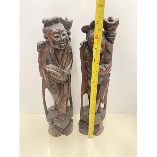 30 - A PAIR OF CARVED HARDWOOD ORIENTAL FIGURES, HEIGHT 34CM