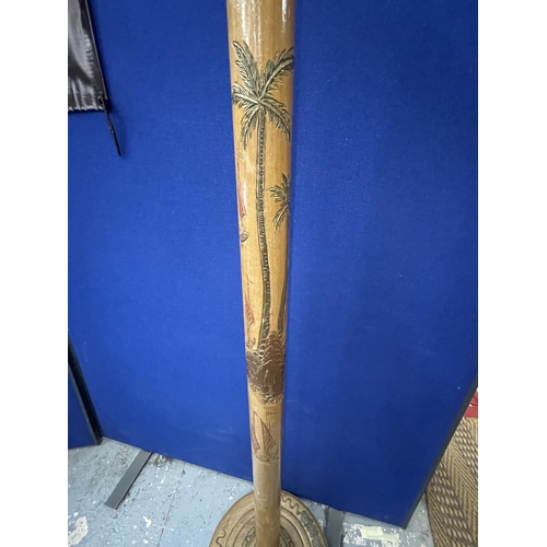 63 - A CARVED WOODEN ORIENTAL STANDARD LAMP