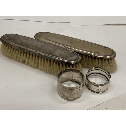 7 - FOUR HALLMARKED SILVER ITEMS - TWO BRUSHES AND TWO NAPKIN RINGS