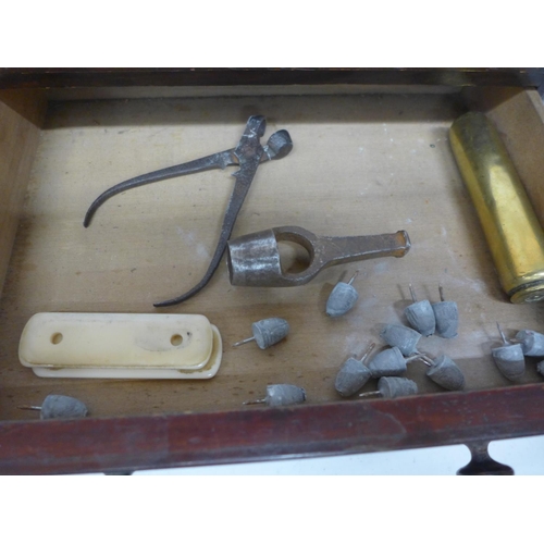 543 - A TWO DRAWER CABINET CONTAINING SHELL CASES, BULLET MOULD, LEAD BULLETS, DIE PUNCH ETC