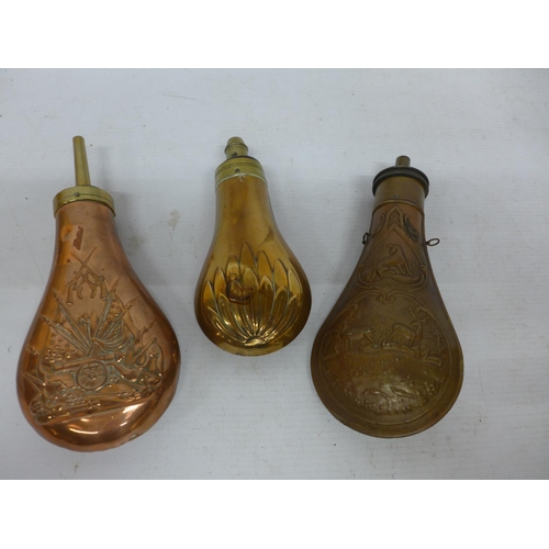 544 - A COLLECTION OF THREE COPPER AND BRASS POWDER FLASKS