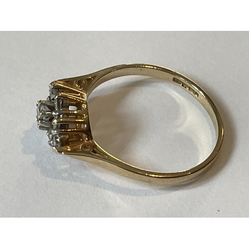 592 - A 9 CARAT GOLD RING WITH NINE CUBIC ZIRCONIAS IN A DIAMOND PATTERN SIZE P