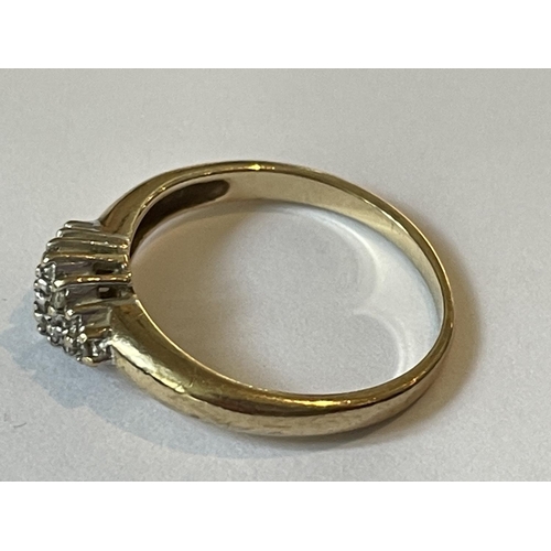 597 - A 9 CARAT GOLD RING WITH DIAMONDS SET IN A DIAMOND SHAPE