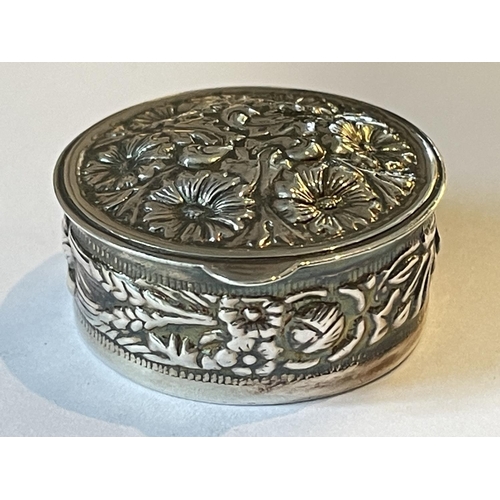 92 - A SILVER CIRCULAR PILL BOX WITH FLORAL DECORATION