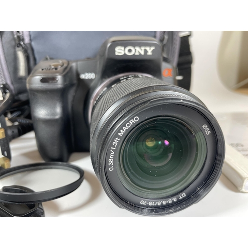 103 - A SONY A200 DIGITAL SLR CAMERA WITH 0.38M/1.3FT MACRO LENS, CHARGER, MANUAL & CASE