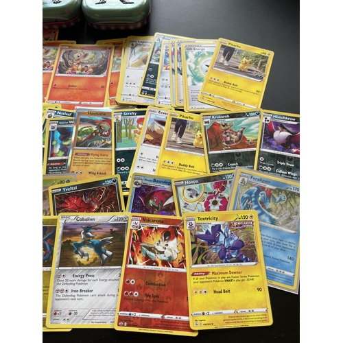 101 - TWO TINS OF ASSORTED POKEMON CARDS, HOLOS ETC