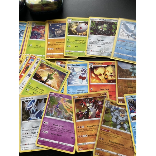 104 - TWO TINS OF ASSORTED POKEMON CARDS, HOLOS ETC