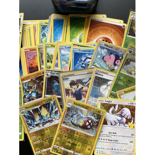 105 - A TIN OF ASSORTED POKEMON CARDS, HOLOS ETC