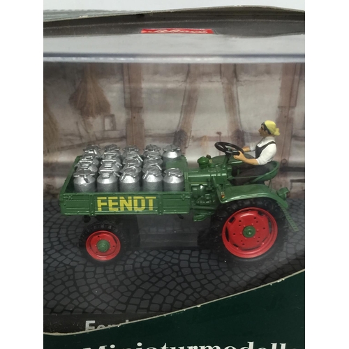 328 - TWO BOXED FARM MODELS, A SCHUCO FENDT TRACTOR, 1/43 SCALE AND A SIKU DEUTZ BALER, 1/32 SCALE