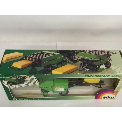 328 - TWO BOXED FARM MODELS, A SCHUCO FENDT TRACTOR, 1/43 SCALE AND A SIKU DEUTZ BALER, 1/32 SCALE