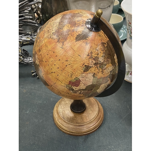 123 - A WORLD GLOBE ON A WOODEN BASE, HEIGHT APPROX 27CM