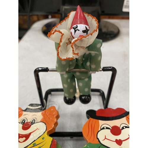 139 - TWO WOODEN PENCIL BOXES IN THE SHAPE OF CLOWNS PLUS AN ACROBATIC CLOWN DESK TOY