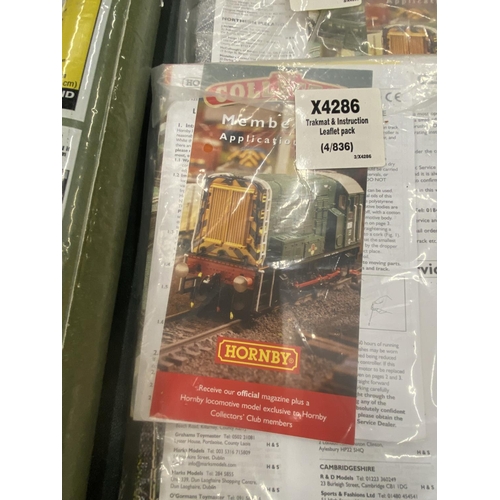 284 - THREE TRAIN MATS TO INCLUDE HORNBY PLUS A ROLL OF 'READY GRASS'