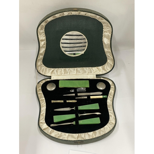 33 - AN ART DECO CASED MANICURE SET WITH JADE STYLE HANDLES