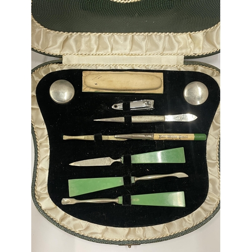 33 - AN ART DECO CASED MANICURE SET WITH JADE STYLE HANDLES