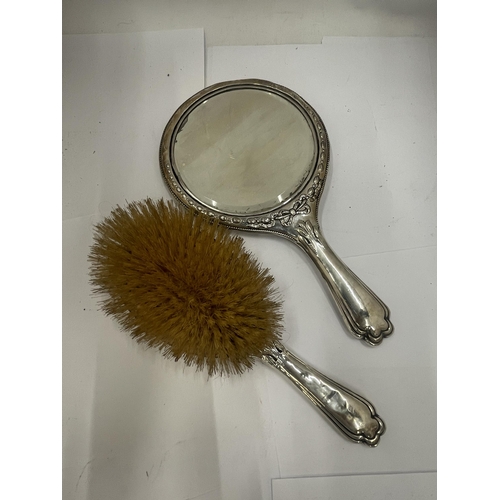 44 - A PAIR OF EDWARDIAN SILVER DRESSING TABLE ITEMS - MIRROR AND BRUSH