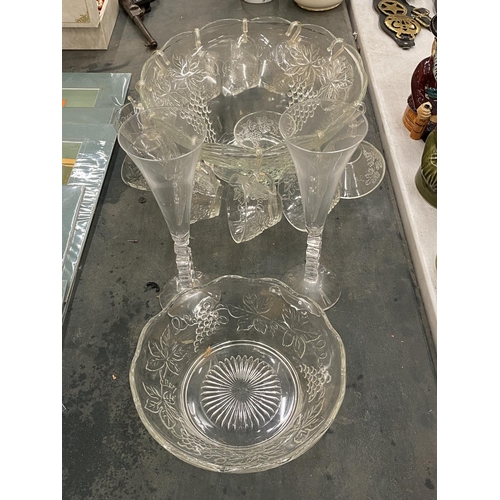 219 - A GLASS PUNCH BOWL WITH CUPS DECORATED WITH GRAPES, TWO CHAMPAGNE FLUTES, ETC