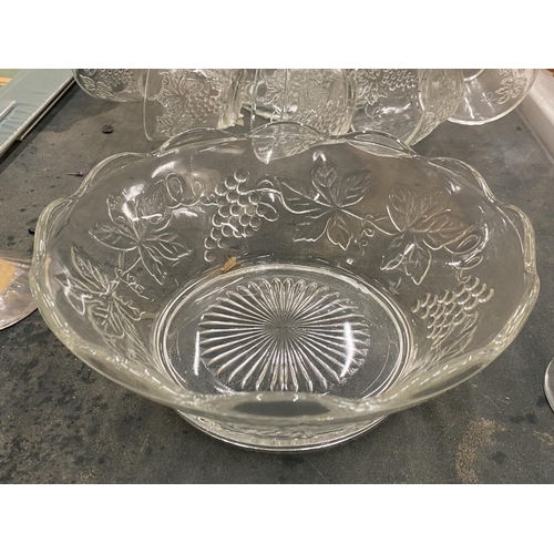 219 - A GLASS PUNCH BOWL WITH CUPS DECORATED WITH GRAPES, TWO CHAMPAGNE FLUTES, ETC