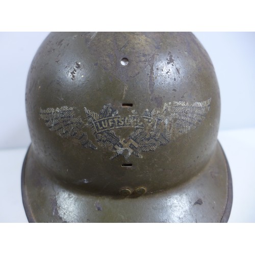 310 - A WORLD WAR II NAZI GERMANY GREEN PAINTED METAL LUFTSCHUTZ HELMET