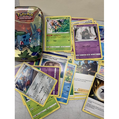 381 - A TIN OF ASSORTED POKEMON CARDS, HOLOS ETC